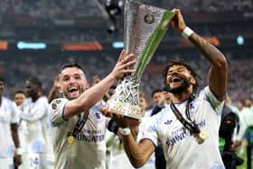 John McGinn and Tyrone Mings of Aston Villa celebrate while holding the UEFA Europa League trophy 