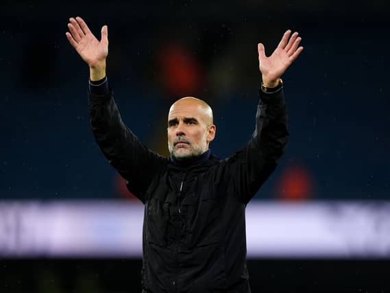 Pep Guardiola raises his arms