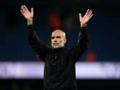 Pep Guardiola raises his arms
