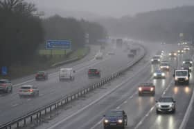 Vehicles drive through the rain on the M40 motorway near Warwick
