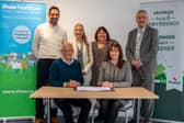  Russell Brown, Shaw Healthcare’s Chief Executive Officer and Nina Davies, Powys County Council’s (PCC) Director of Social Services and Wellbeing signing the new 15-year contract. With them are back row, from left to right: Geraint Evans, Shaw’s Operations Director; Rachel Evans, PCC’s Senior Strategic Commissioning Manager; Sharon Frewin, PCC’s Head of Adult Services; and Peter Lathbury, Strategic Commissioning Manager – Age Well.