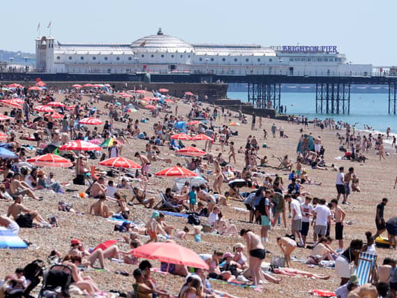 A view of the beach as people enjoy the hot weather in Brighton, East Sussex