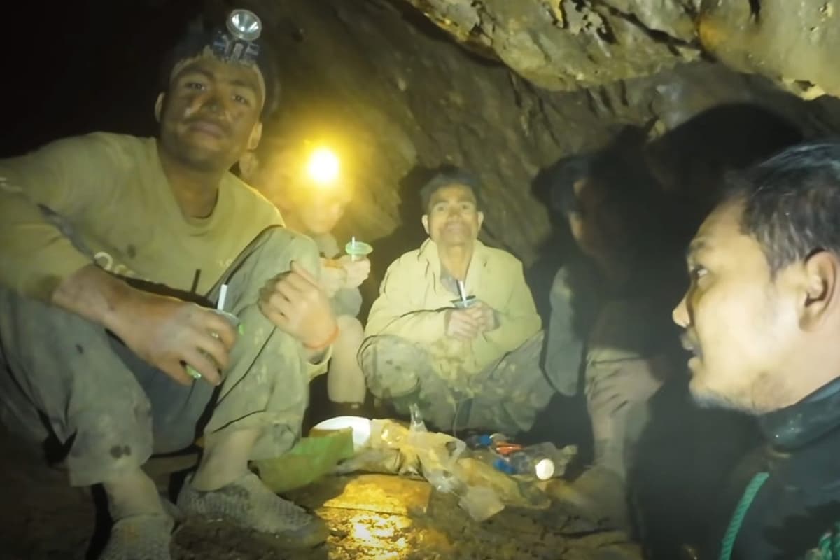 Rescuers evacuate the first of five villagers found trapped in a cave in ...