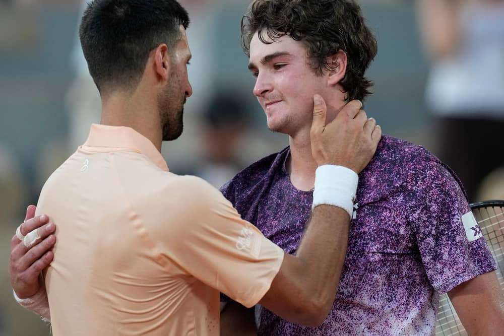 Joao Fonseca, right, is embraced by Novak Djokovic after his win at the French Open