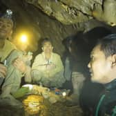 Rescuers speaking to the villagers who were trapped and found in a flooded cave in Xaisomboun province, Laos