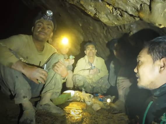 Rescuers speaking to the villagers who were trapped and found in a flooded cave in Xaisomboun province, Laos