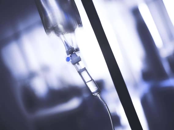 Intravenous drip system in obscure ward.