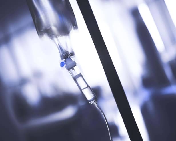 Intravenous drip system in obscure ward.