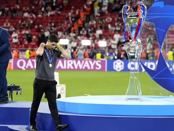 Arsenal manager Mikel Arteta walks past the trophy following defeat