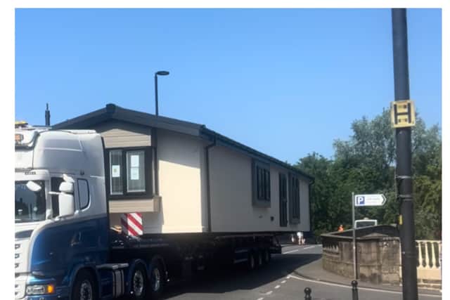A lorry carrying a caravan caused “chaos” as it was forced to reverse back over a tight bridge.