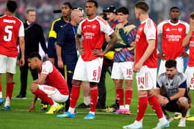Arsenal’s Gabriel (centre) stands dejected with team-mates following defeat in the Champions League final