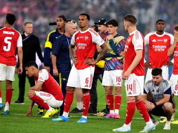 Arsenal’s Gabriel (centre) stands dejected with team-mates following defeat in the Champions League final