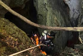A rescuer entering a cave in Laos