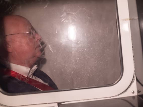 Peter Murrell in the back of a prison van