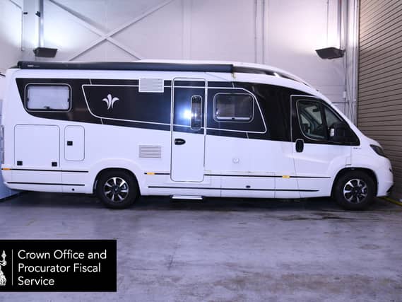 Side view of a large motorhome in a garage