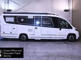 Side view of a large motorhome in a garage