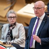 John Swinney standing while speaking in Holyrood