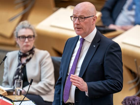 John Swinney standing while speaking in Holyrood