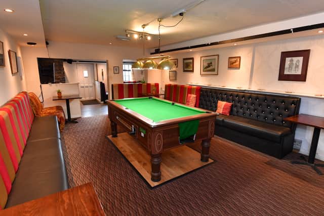 The pool table sits at one end of the pub