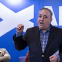 Alex Salmond speaking in front of Alba Party signage