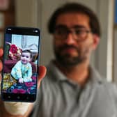 Fahd Abu Haikal displays a mobile phone photo of his seven-month-old baby boy Sam, who was killed on Friday when Israeli soldiers fired at the vehicle carrying him and his parents, in Tel Rumeida, at a hospital in the West Bank city of Hebron