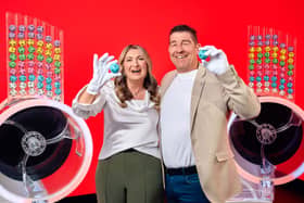 Lotto winners look cheerful