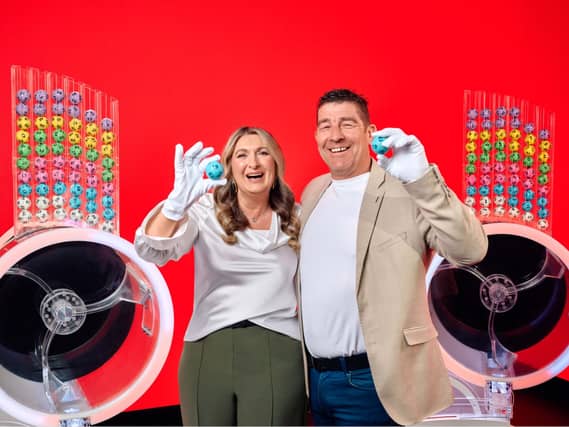 Lotto winners look cheerful