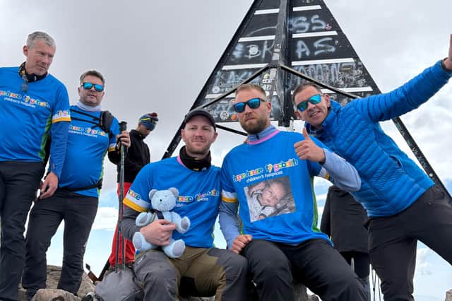 Adam Blackburn (front centre left) with Barney Bear and Ben Mates (front centre right) in his special T-shirt featuring his son Reggie.