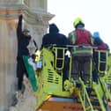 Emergency services talking to Daniel Day after he climbed up Elizabeth Tower at the Palace of Westminster
