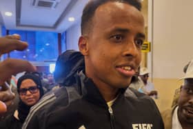 Referee Omar Artan, in a FIFA tracksuit jacket, arrives home in Somalia after being denied entry to the United States for the World Cup