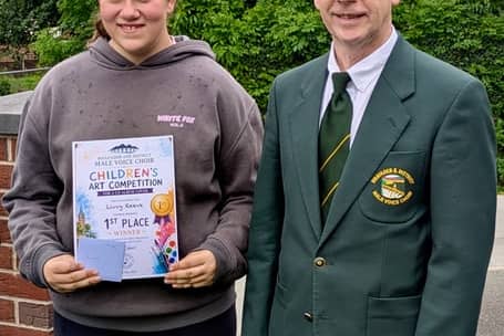 Livvy, 12, the competition winner with a member of Rhayader Male Voice Choir.