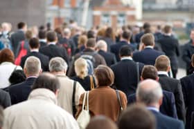 Large crowd of commuters on their way from work during rush hour in the City of London, England, UK