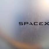 The SpaceX logo on a blurred window