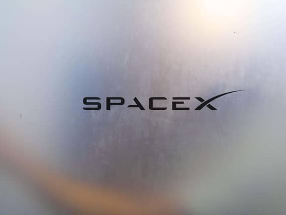 The SpaceX logo on a blurred window