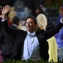 Elon Musk raises his arms