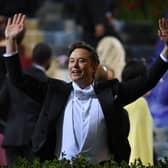 Elon Musk raises his arms