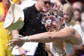 A woman throwing a custard pie