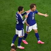 Koki Ogawa, right, and Daichi Kamada celebrate Japan's leveller