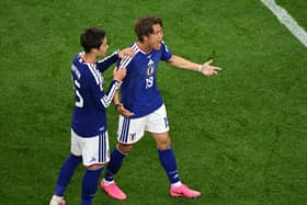 Koki Ogawa, right, and Daichi Kamada celebrate Japan's leveller
