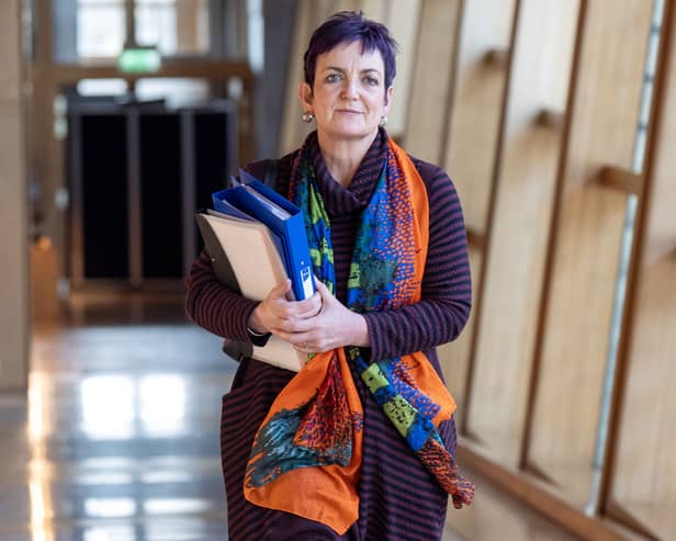 Angela Constance carrying a folder in a Holyrood corridor