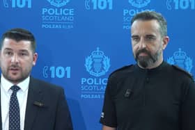 Two senior police officers in front of a blue background