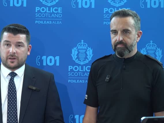 Two senior police officers in front of a blue background