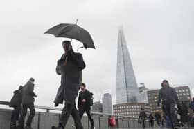A person walking holding an umbrella