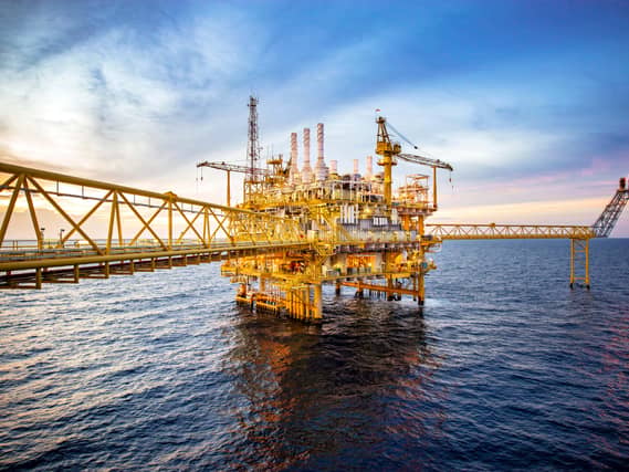 Large offshore drilling rig in the Gulf at sunset