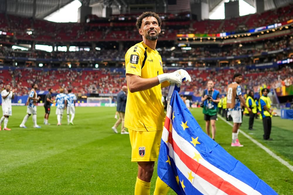 Vozinha holds a Cape Verde flag after the draw with Spain