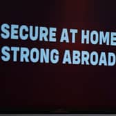 The words 'secure at home, strong abroad' in the foreground following a speech by Sir Keir Starmer last year