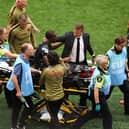 Canada head coach Jesse Marsch consoles Ismael Kone as he is carried off the field on a stretcher in the 6-0 World Cup win over Qatar