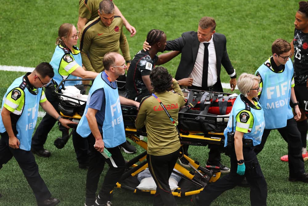 Canada head coach Jesse Marsch consoles Ismael Kone as he is carried off the field on a stretcher in the 6-0 World Cup win over Qatar