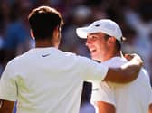 Oliver Tarvet, right, talks to Carlos Alcaraz after their match at Wimbledon