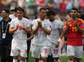 Iran players clap spectators after their goalless draw with Iran